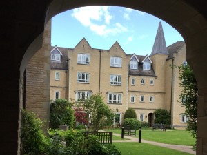 lawn and buildings seen through archway. Photo by HelpStation